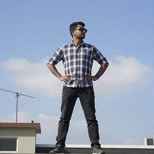 Confident Man on Rooftop Under Clear Sky