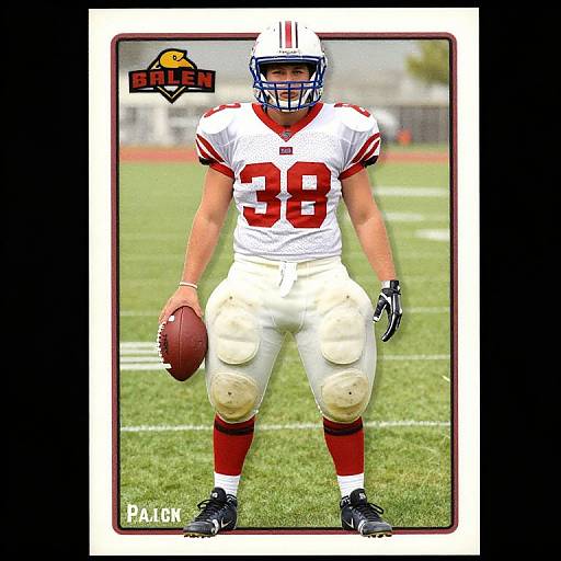 Photograph of a muscular male football player in white and red uniform, number 38, holding a football, standing on a grass field. 