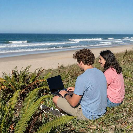 Couple on Beach Dunes with Laptop