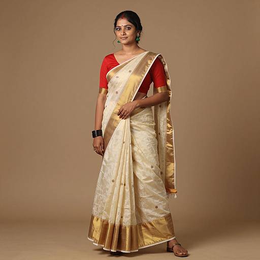 Indian Woman in Traditional Cream and Gold Saree