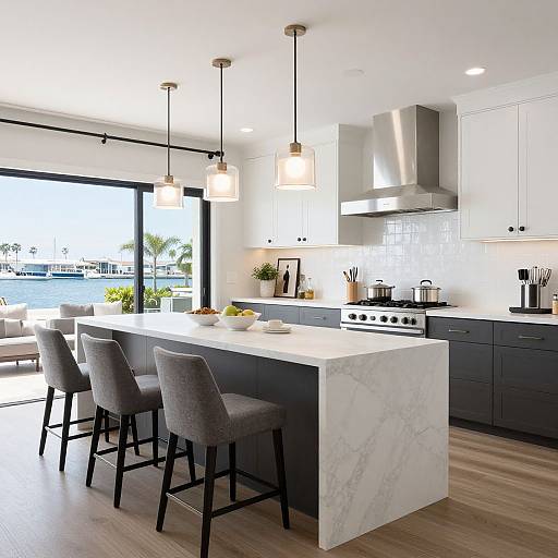 Modern kitchen photograph: white marble island with gray cushioned bar stools, stainless steel appliances, black cabinets, hanging pendant lights, large window with water view