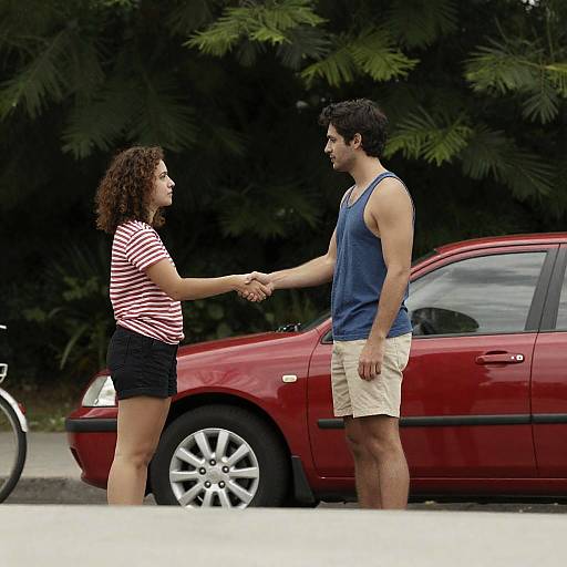 Outdoor Handshake by a Red Car