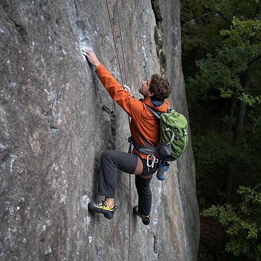Determined Rock Climber Conquering Gray Wall