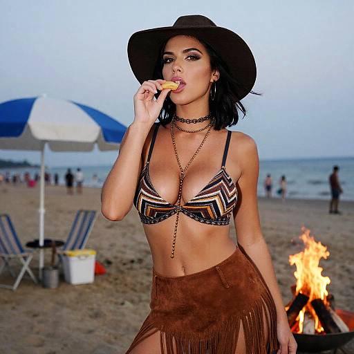 Photograph of a curvy woman with tan skin, black hair, and large breasts, wearing a geometric bikini top, brown fringe skirt, black hat