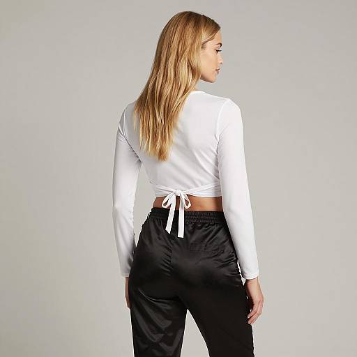 Blonde Woman in White Crop Top and Black Satin Pants Back View