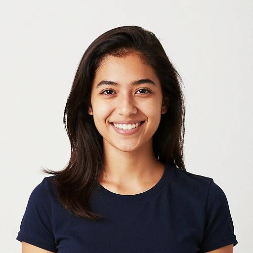 Photograph of a smiling young woman with long dark hair, medium brown skin, and brown eyes, wearing a black t-shirt, against a plain white