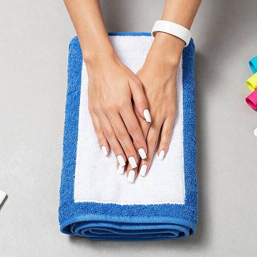 Hands with White Nails on Towel