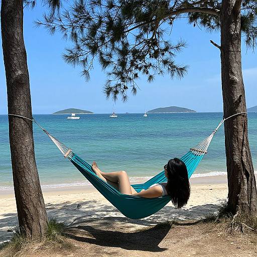 Woman Relaxing in Teal Hammock by Ocean