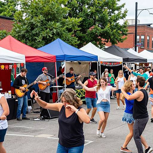 Photograph of a lively outdoor festival with musicians in striped shirts and hats playing guitars under colorful tents, and dancing women in jeans and tank tops in the