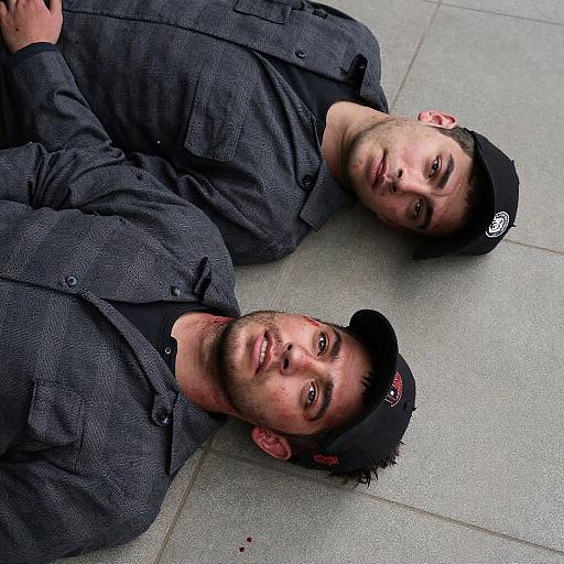 Two Bloodied Men Lying on Tiled Ground