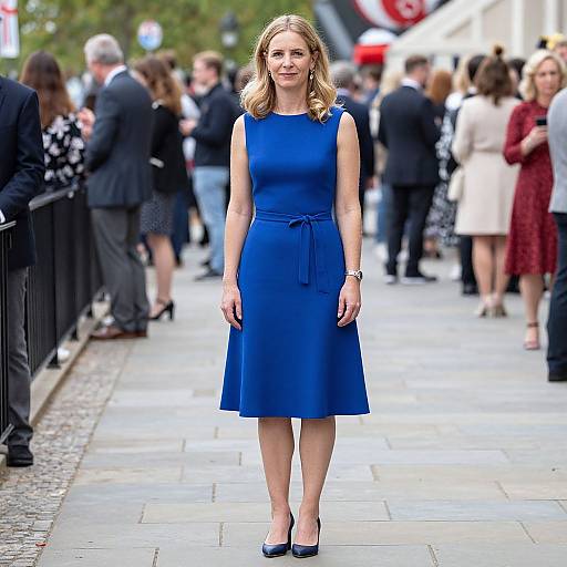 Woman in Blue Dress on Sidewalk