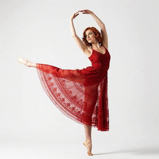 Ballet dancer in red dress arabesque pose