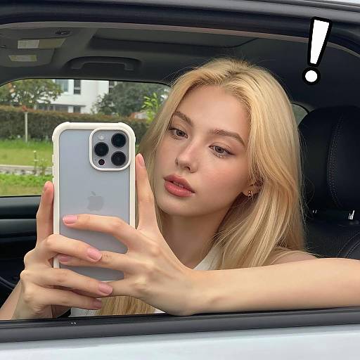 Blonde Woman Taking a Car Selfie