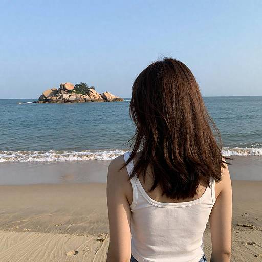 Woman on Beach Facing Rocky Island