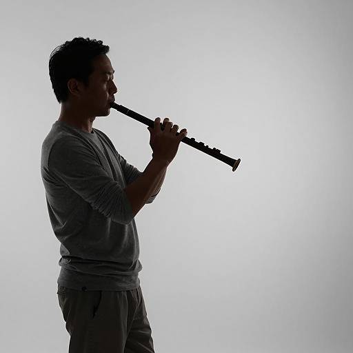 Silhouetted Flutist in Gray Gradient Background
