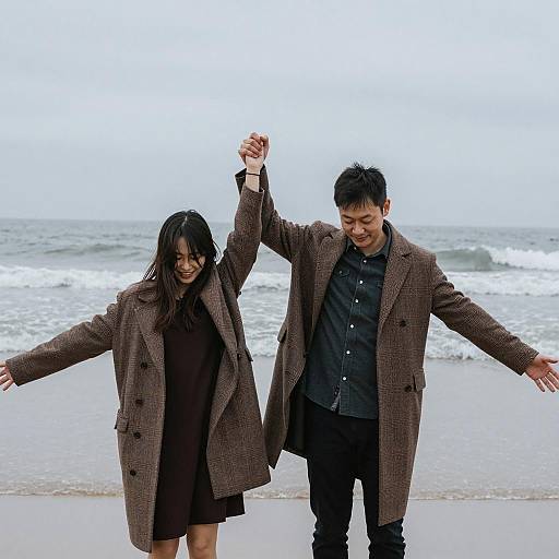 Couple Holding Hands on Overcast Beach