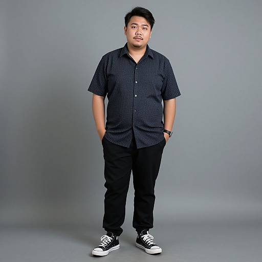 Photograph of a young Asian man with short black hair, medium build, wearing a black checkered shirt, black pants, and black-and-white sneakers