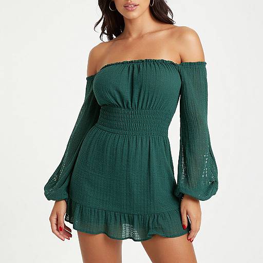 Photograph of a woman with long dark hair, wearing an off-shoulder, dark green, textured, long-sleeve mini dress with lace