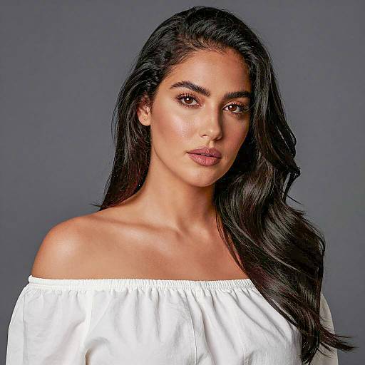 Portrait of woman with long wavy hair in white blouse