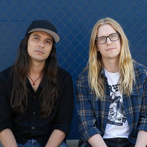 Two Men Sitting by Blue Chain-Link Fence