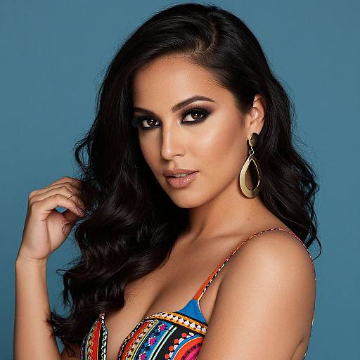 Photograph of a beautiful woman with long, wavy black hair, wearing a colorful, patterned top, large gold earrings, and looking directly at