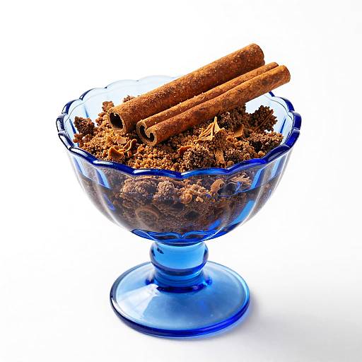 Blue Glass Dish with Crumbly Dessert and Cinnamon Sticks