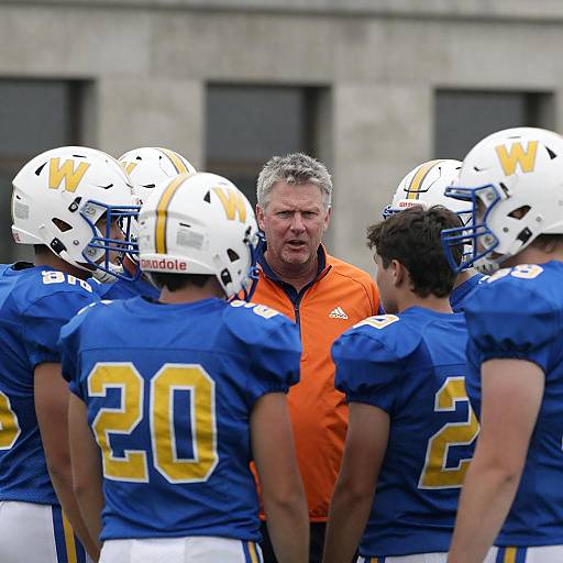 Youth Football Team Huddled with Coach