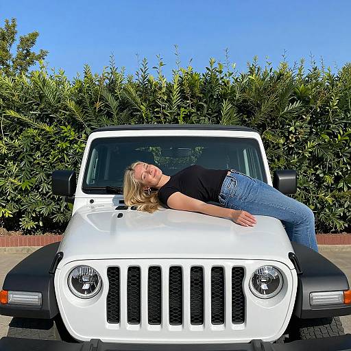 Smiling Woman on Jeep Under Clear Sky