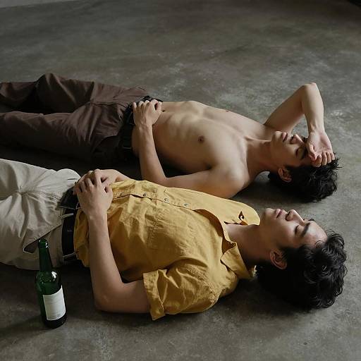 Two Men Resting on Concrete Floor