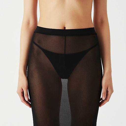 Photograph of a woman's waist and hips, wearing sheer black pantyhose and black thong, against a plain white background.
