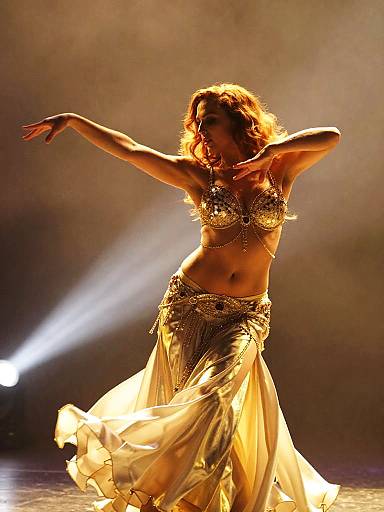 Dynamic Belly Dance Performance in Gold Costume