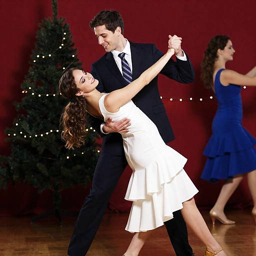 Elegant Couple Dancing with Festive Backdrop