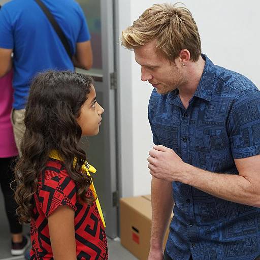 Man Talking to Young Girl Indoors