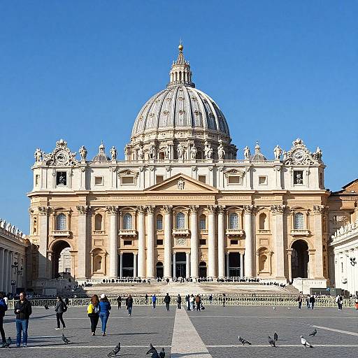 Photograph of St. Peter's Basilica in Vatican City, featuring its grand dome, classical architecture, clear blue sky, and people walking in the