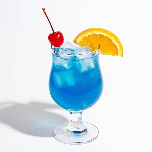 Photograph of a blue cocktail glass filled with ice and blue liquid, garnished with a cherry and orange slice, against a white background.