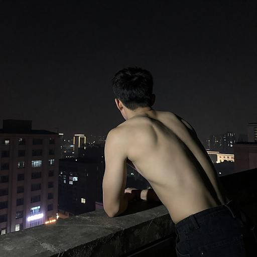 Muscular Man Overlooking City Nightscape