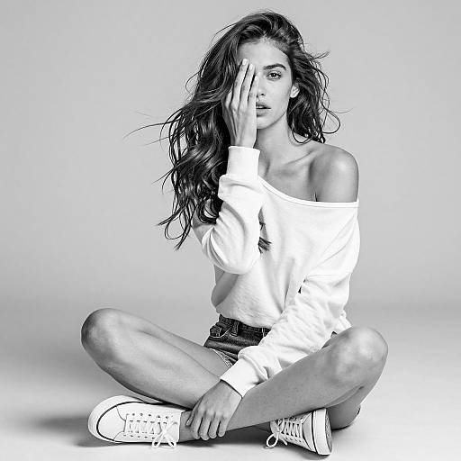 Black and white portrait of young woman sitting on floor