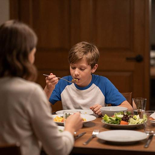 Young Boy Eating Dinner at Home