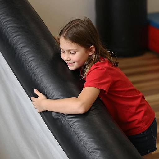 Cheerful Girl Embracing Inflatable Slide