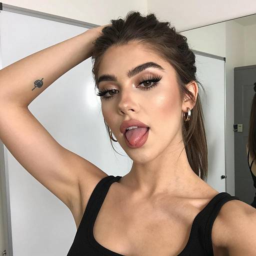Young Woman Taking Selfie with Tongue Out