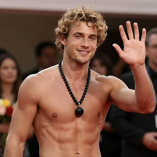 Shirtless muscular man waving indoors