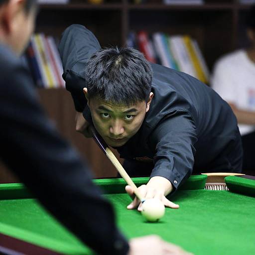 Man aiming shot on pool table