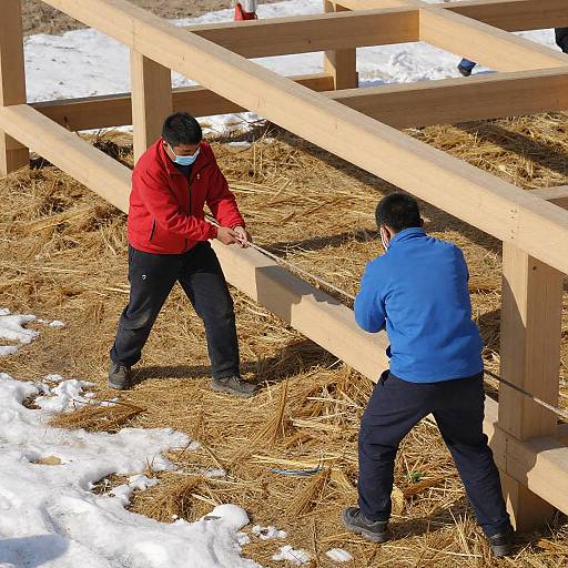 Men Pulling Ropes on Snowy Ground