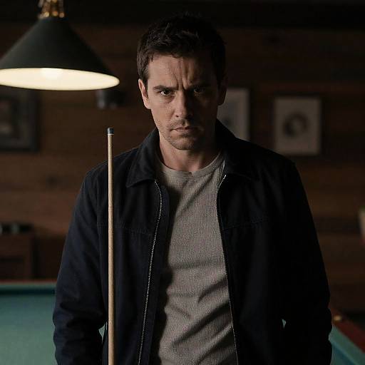 Focused Man with Pool Cue in Rustic Room