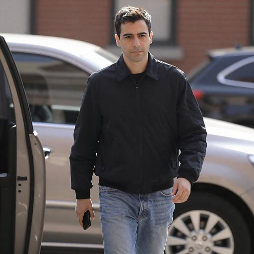 Man Walking Outdoors in Black Jacket