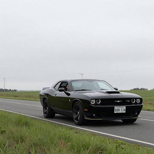 Sleek Black Muscle Car on Scenic Road