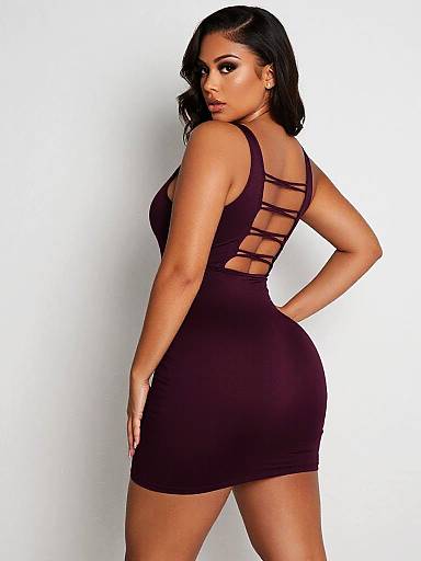 Photograph of a curvy woman with dark skin and black hair, wearing a tight, backless, strappy black mini dress, looking over her
