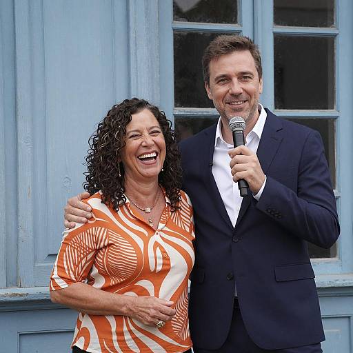 Middle-aged Woman and Man with Microphone Smiling Outdoors