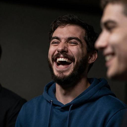 Intense Laughter: Bearded Man in Hoodie