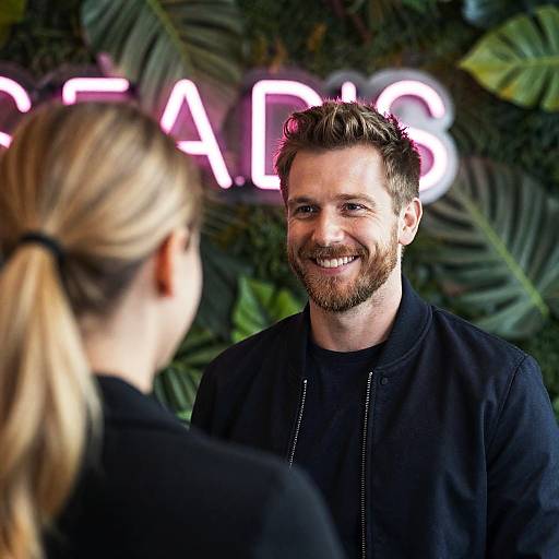 Smiling Man Talking to Woman Indoors